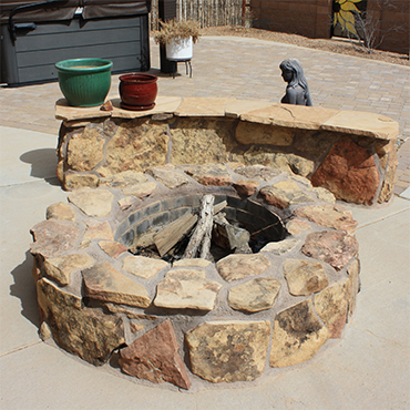 Fire pit with banco seating area by Whelchel Landscape and Construction